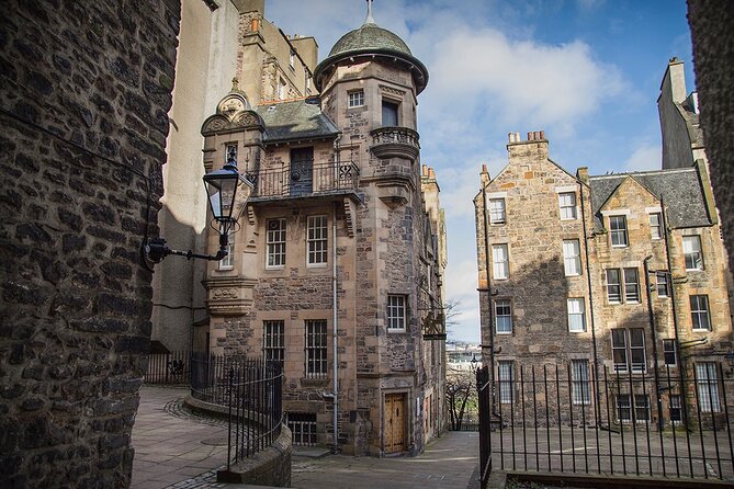 Edinburgh Castle & Royal Mile Walking Tour - Ticket Included - Climbing up to Edinburgh Castle esplanade, with views worth it